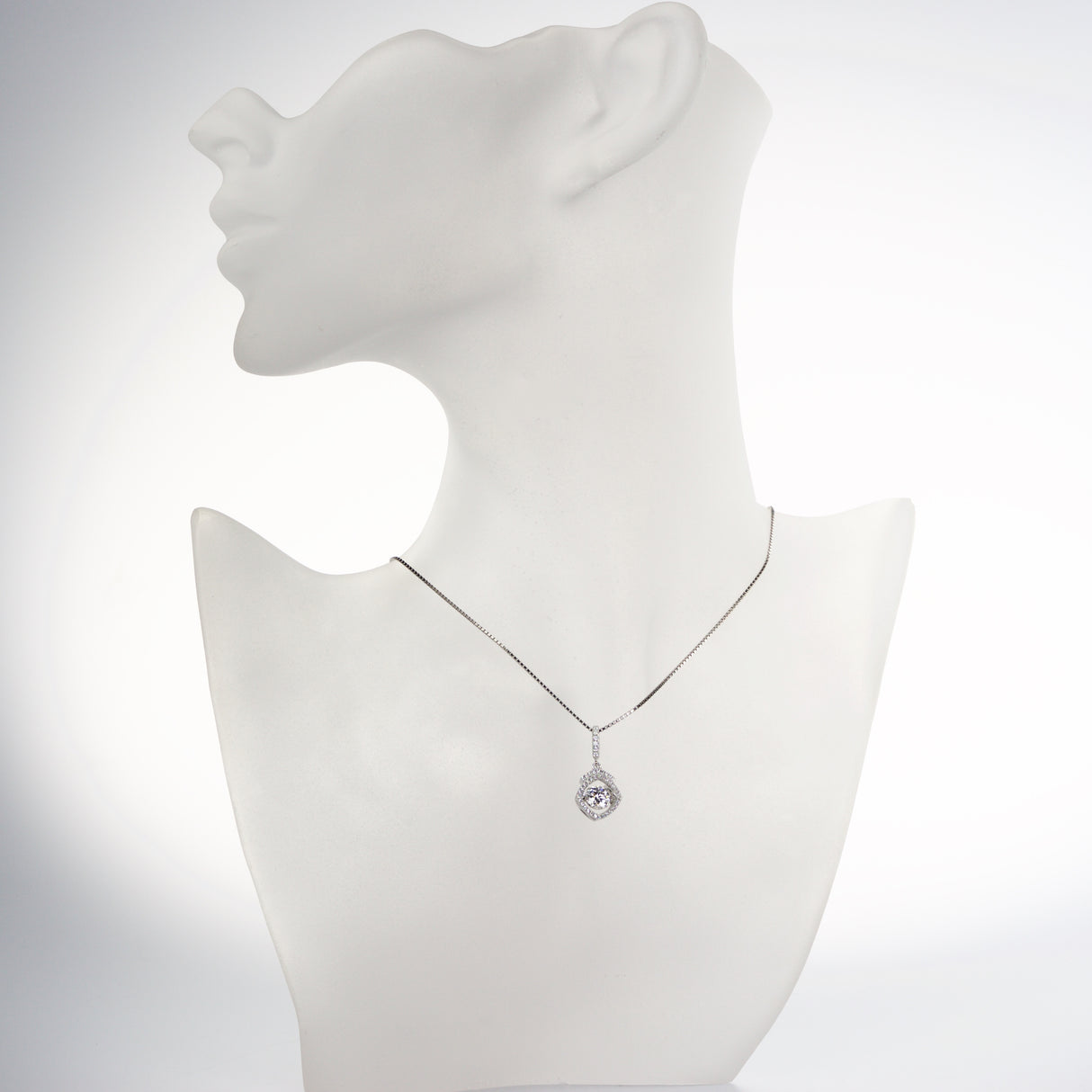 Close-up of a dancing gemstone in square halo.