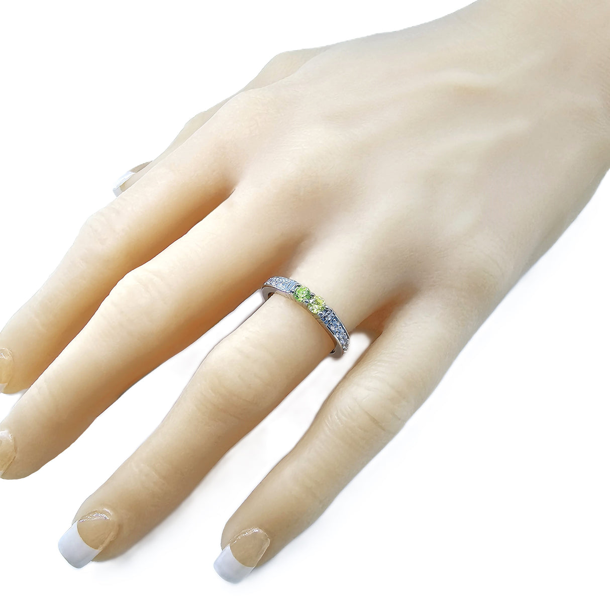 Detail of the shared prong setting and two birthstones.