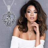 Heart dancing gemstone necklace on jewelry display.